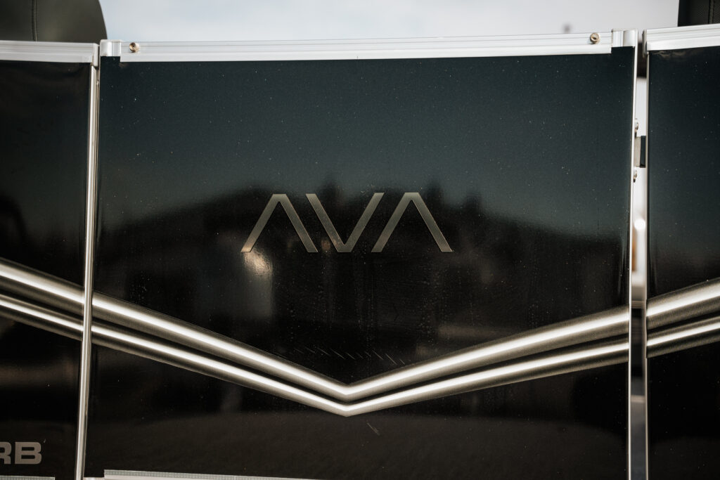 Avalon logo on sleek black panel of 2026 Avalon LSZ boat, highlighting luxury and design features.