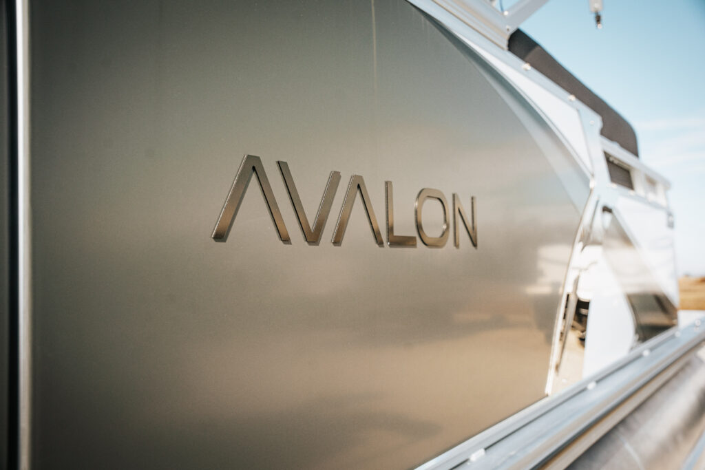 Avalon logo on the side of a 2026 Avalon LSZ boat, showcasing the sleek white and grey design.