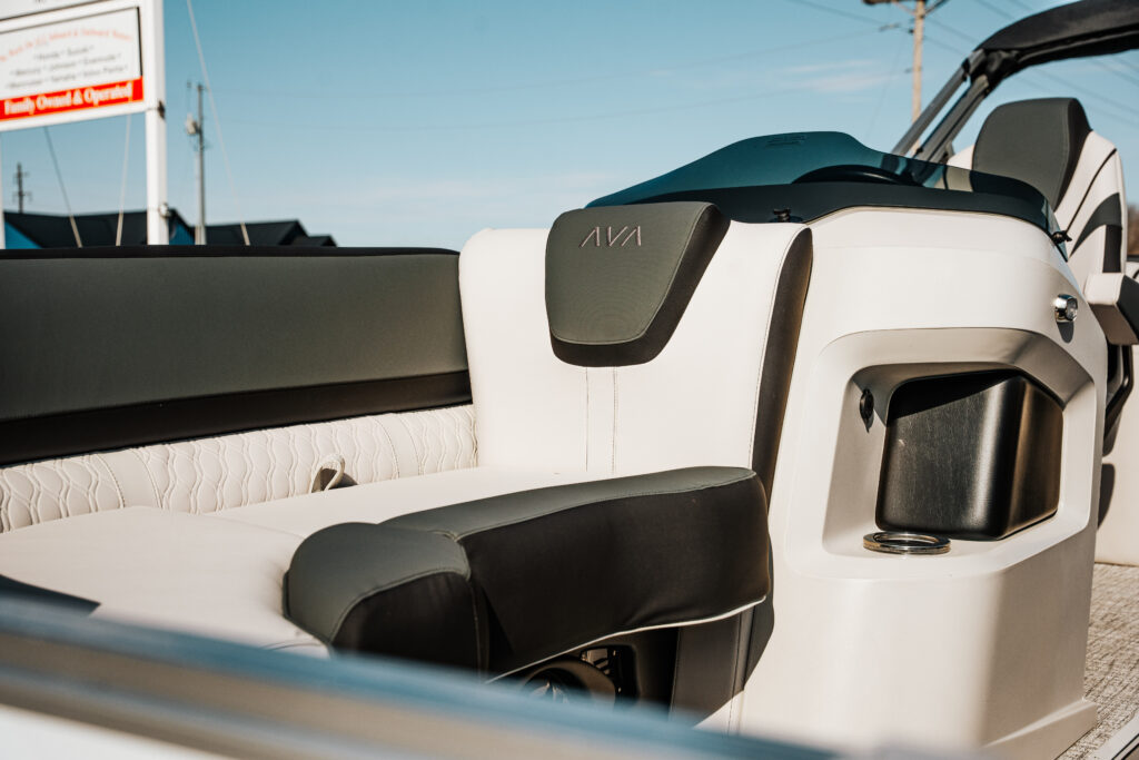 Interior seating of the 2026 Avalon LSZ boat featuring white and grey ultrafine vinyl upholstery, sport high back reclining chair, and AVA branding, showcasing premium design and comfort.