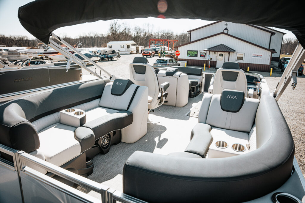 Interior view of the 2026 Avalon LSZ boat featuring plush seating in white and grey, including high back reclining chairs and built-in cup holders, showcasing a modern design suitable for leisure and comfort.