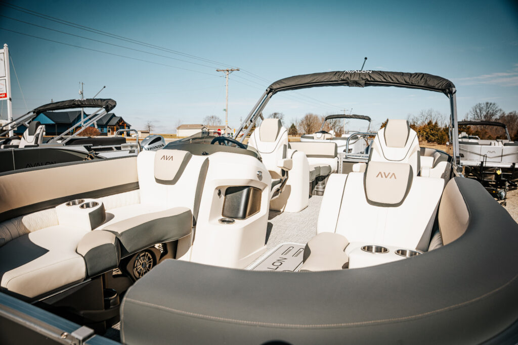 Avalon Catalina Quad Lounger interior with plush seating, charcoal and white upholstery, featuring AVA branding, designed for comfort and style in a marine setting.