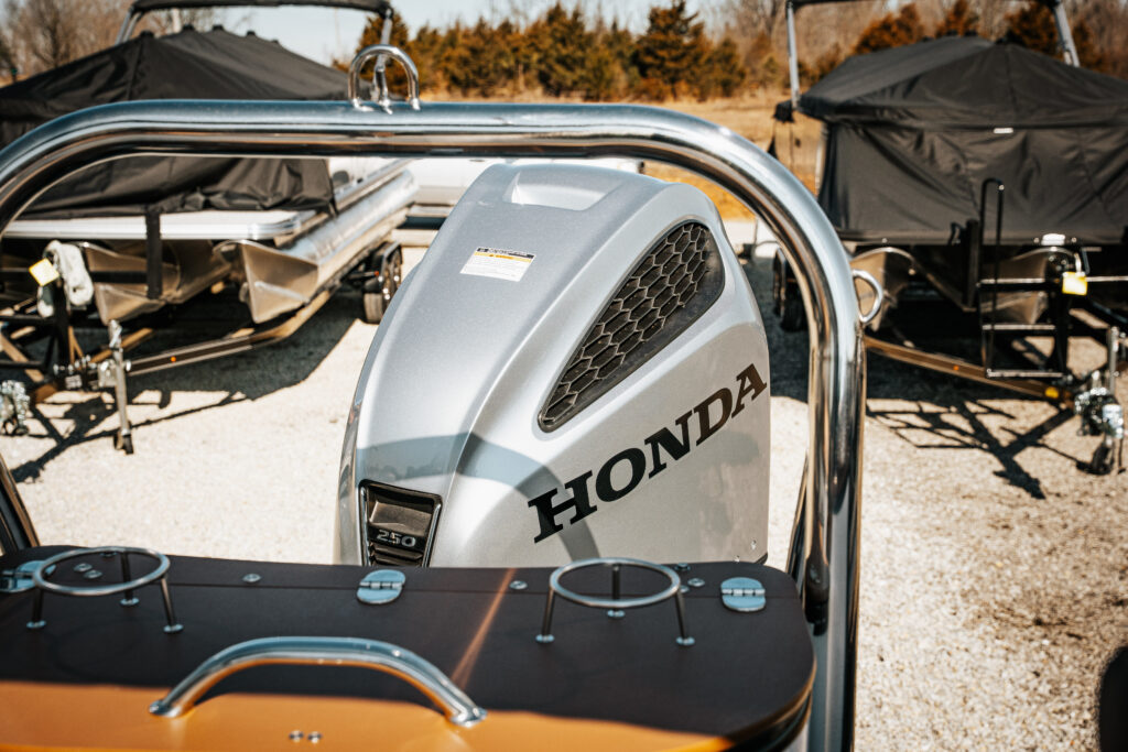 Honda 250 HP outboard motor, showcased on 2026 Avalon Catalina boat, with surrounding boats in background, highlighting premium marine features.