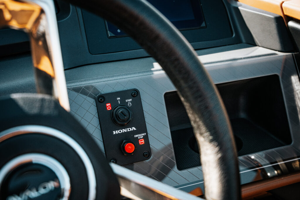 Honda control panel with start and emergency stop buttons in the 2026 Avalon Catalina boat interior, showcasing premium design and functionality.