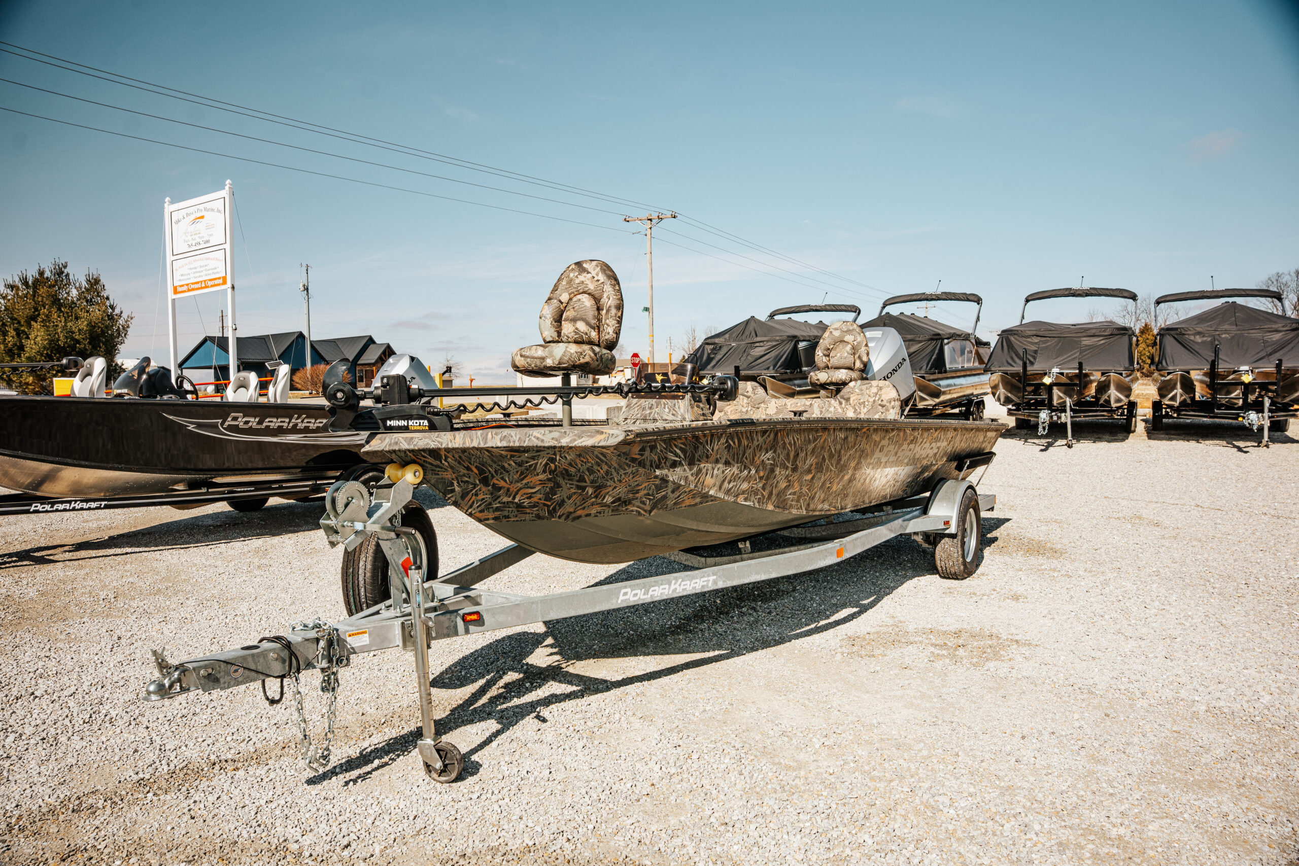 2024 Polar Kraft Frontier 165 SC boat on display with camouflage seating, part of Mike & Dave's Pro Marine inventory.