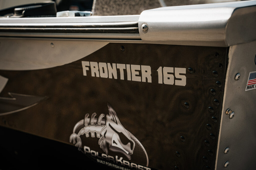 Frontier 165 branding on the side of the 2024 Polar Kraft boat, showcasing the model name and logo, with a focus on design details and craftsmanship.
