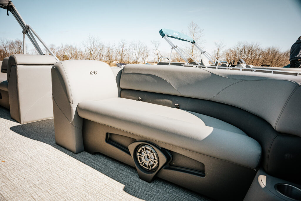 Avalon Venture Quad Lounger interior seating with gray upholstery, featuring a sleek design and integrated speakers, showcasing comfort and style for a boat designed to seat 10 people.