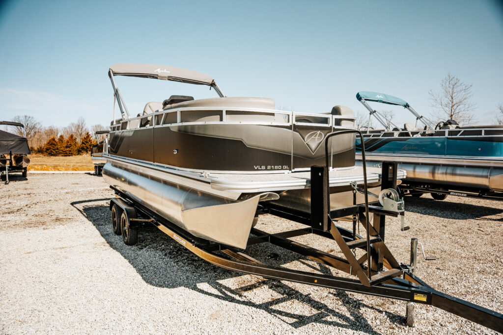 Pre-owned Avalon VLS 2180 GL pontoon boat on trailer, showcasing sleek design and spacious seating, available for sale at Mike & Dave's Pro Marine.